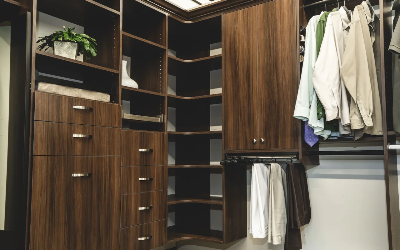 Wood-grain walk-in closet with drawer stacks, corner shelving, a tall cabinet and a pull-out pants rack