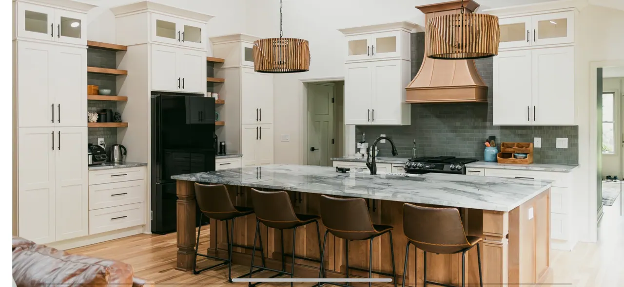 Panoramic white kitchen with wood hood and long island