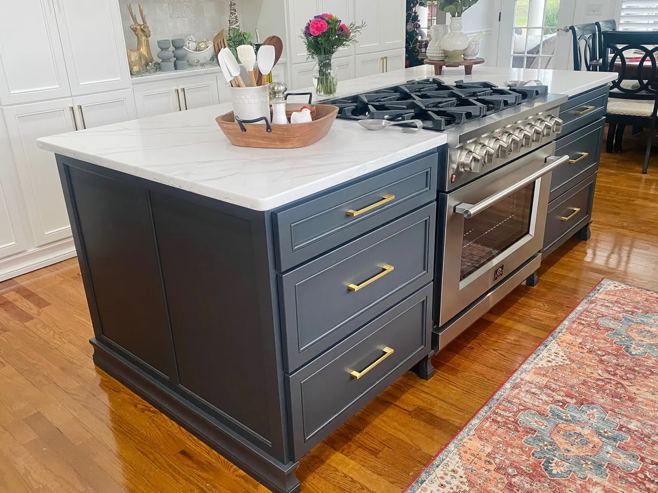 Navy island drawers beside a professional range