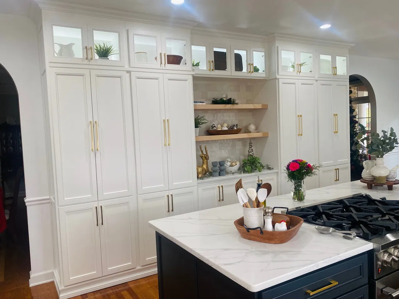 White built-in hutch with open shelves and navy island