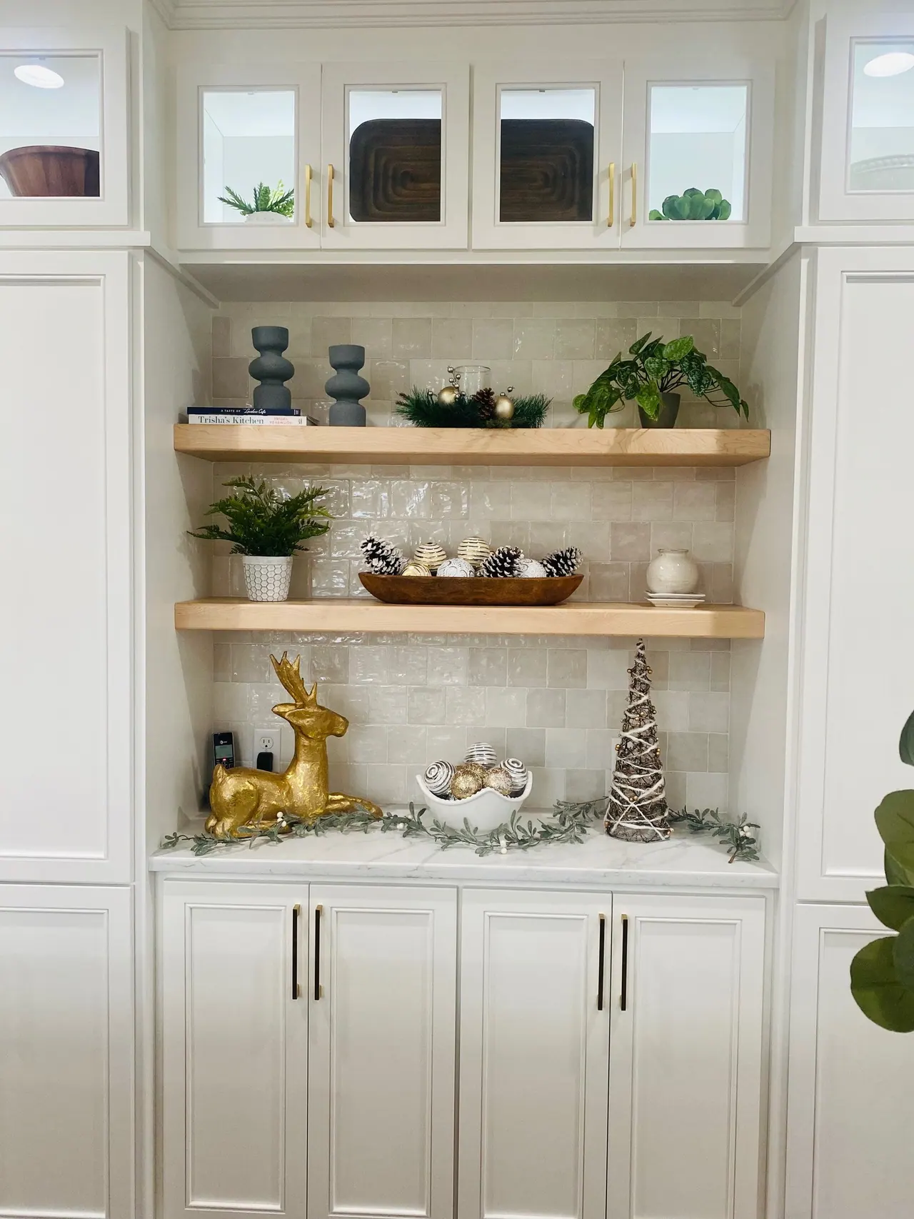 Open shelving niche in white cabinetry