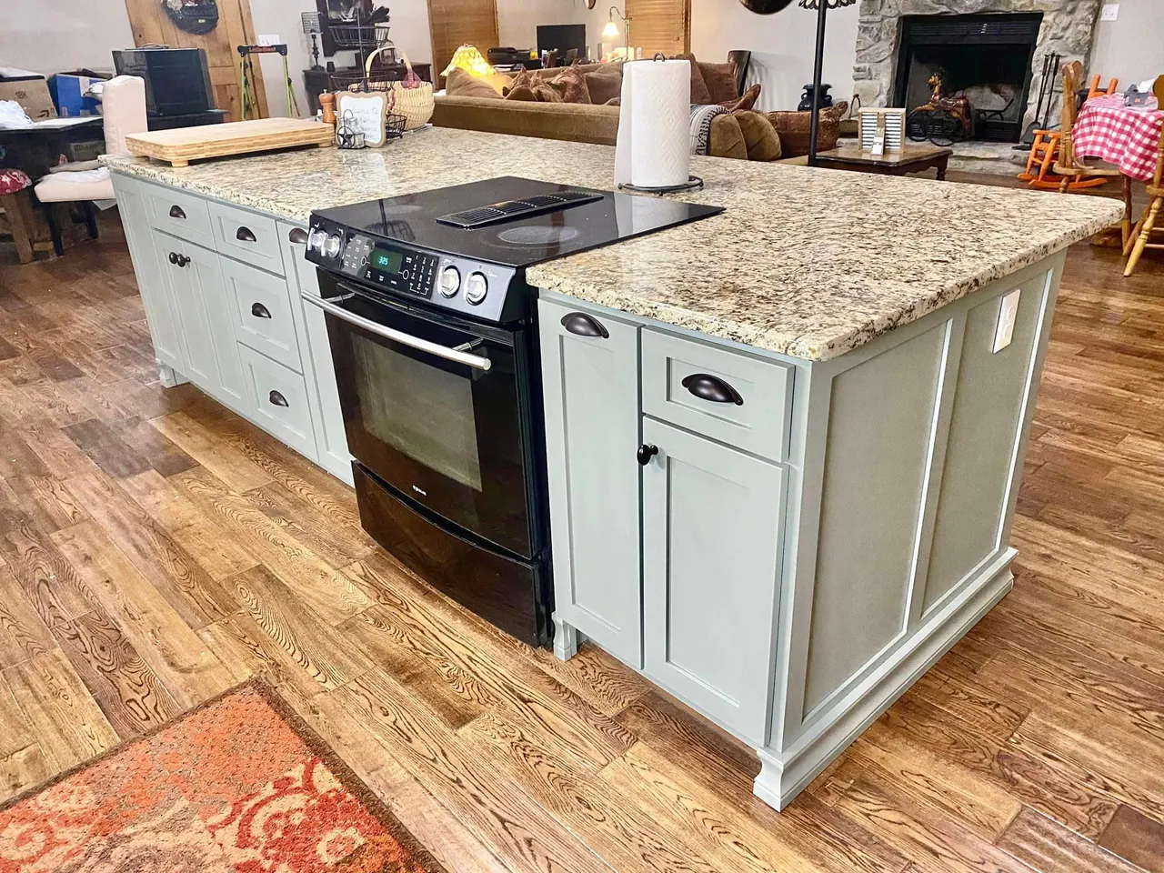 Sage island with range and granite countertop