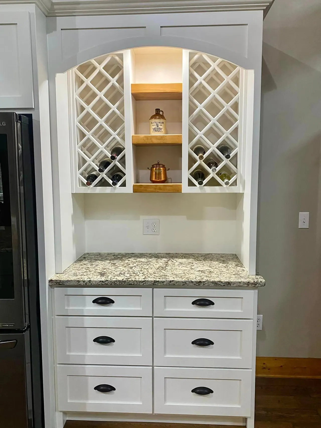 White hutch with lit wine lattice and glass doors