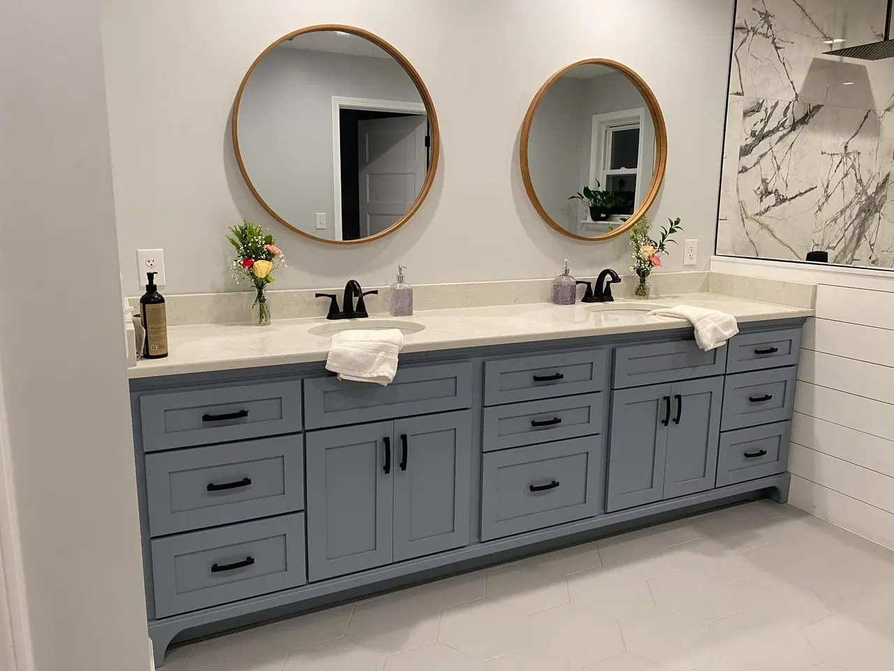 Blue double vanity with white top and round mirrors
