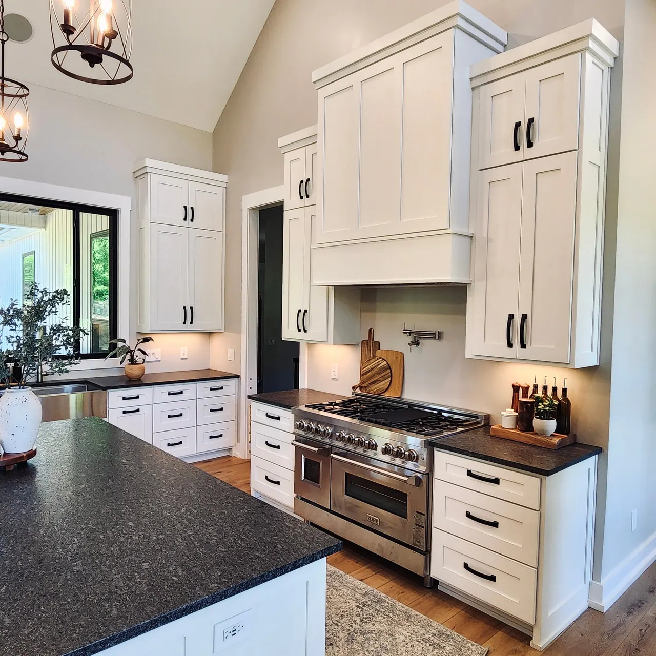 White kitchen with stacked uppers and professional range