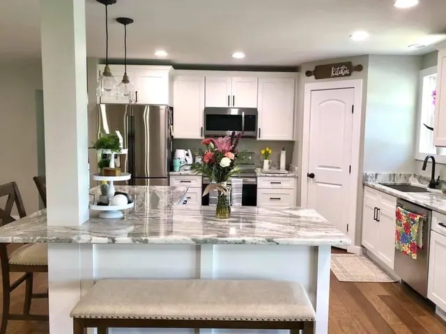 White kitchen island under pendants