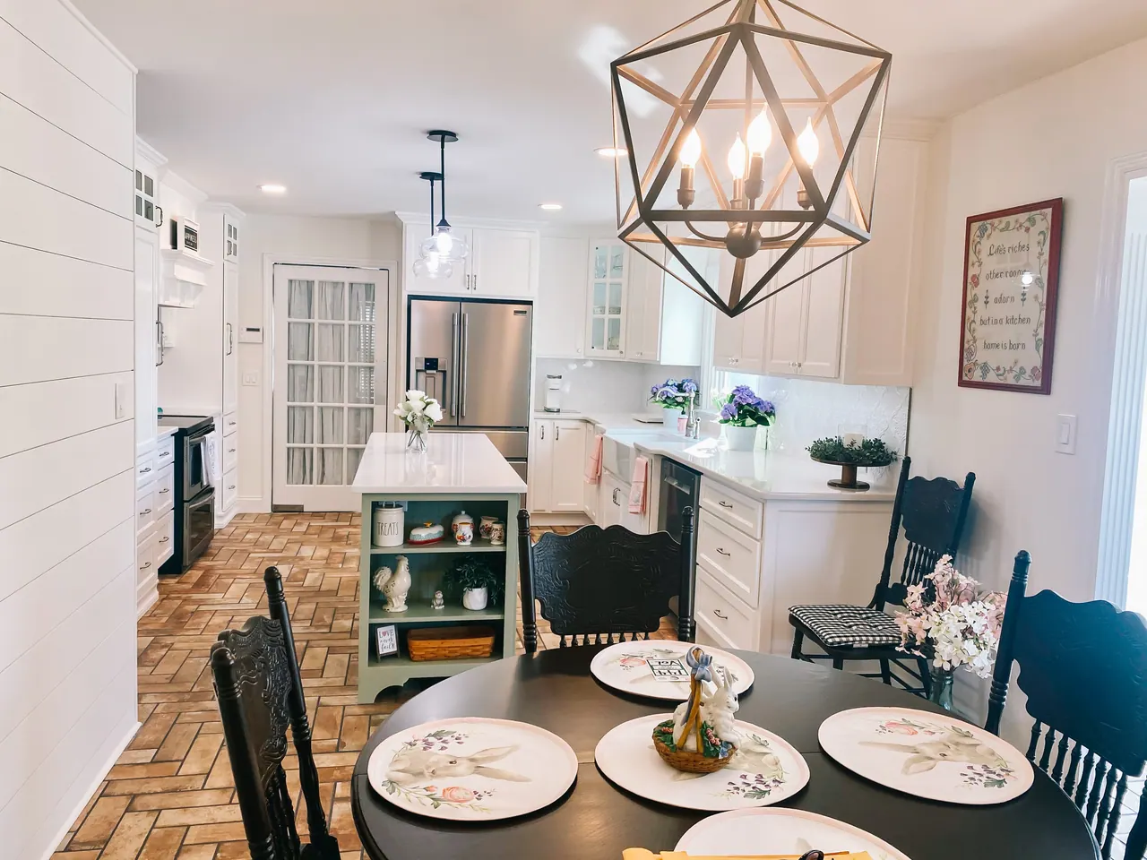Dining view of white kitchen and island