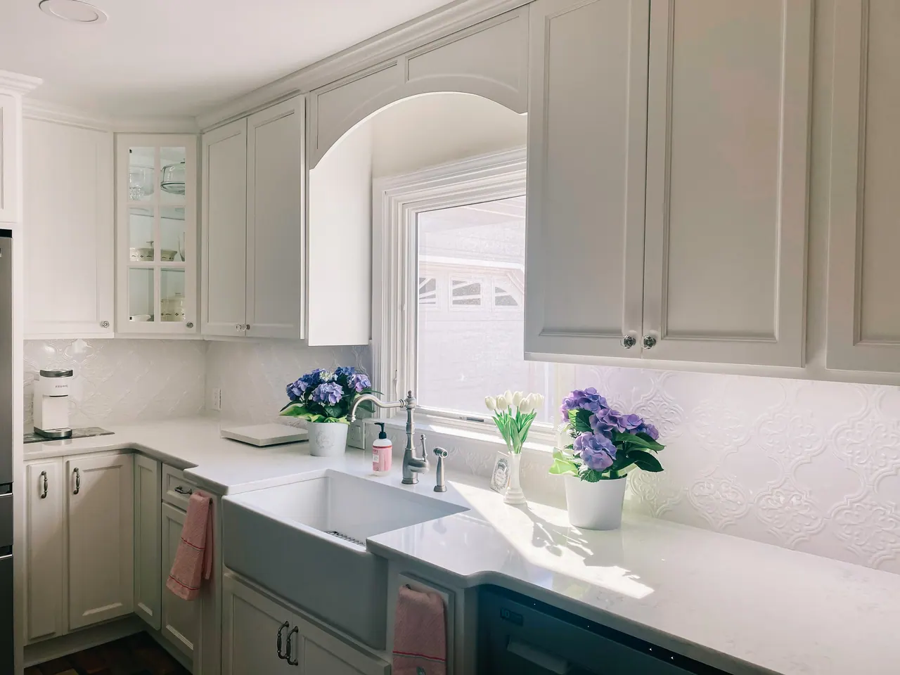 White shaker cabinets with apron-front sink
