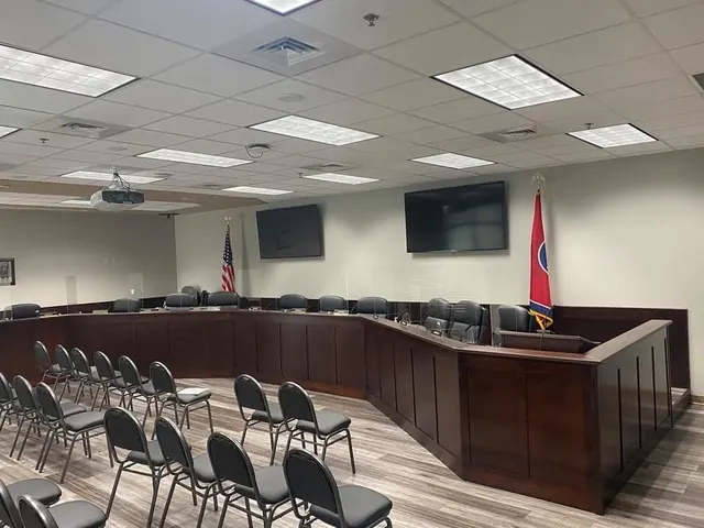 Custom dark wood dais and millwork in a public meeting chamber