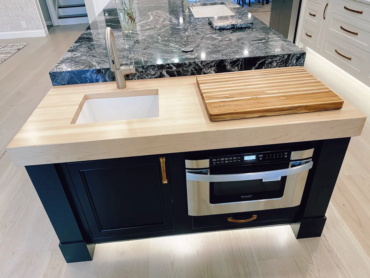 Island prep sink with butcher block and built-in microwave drawer