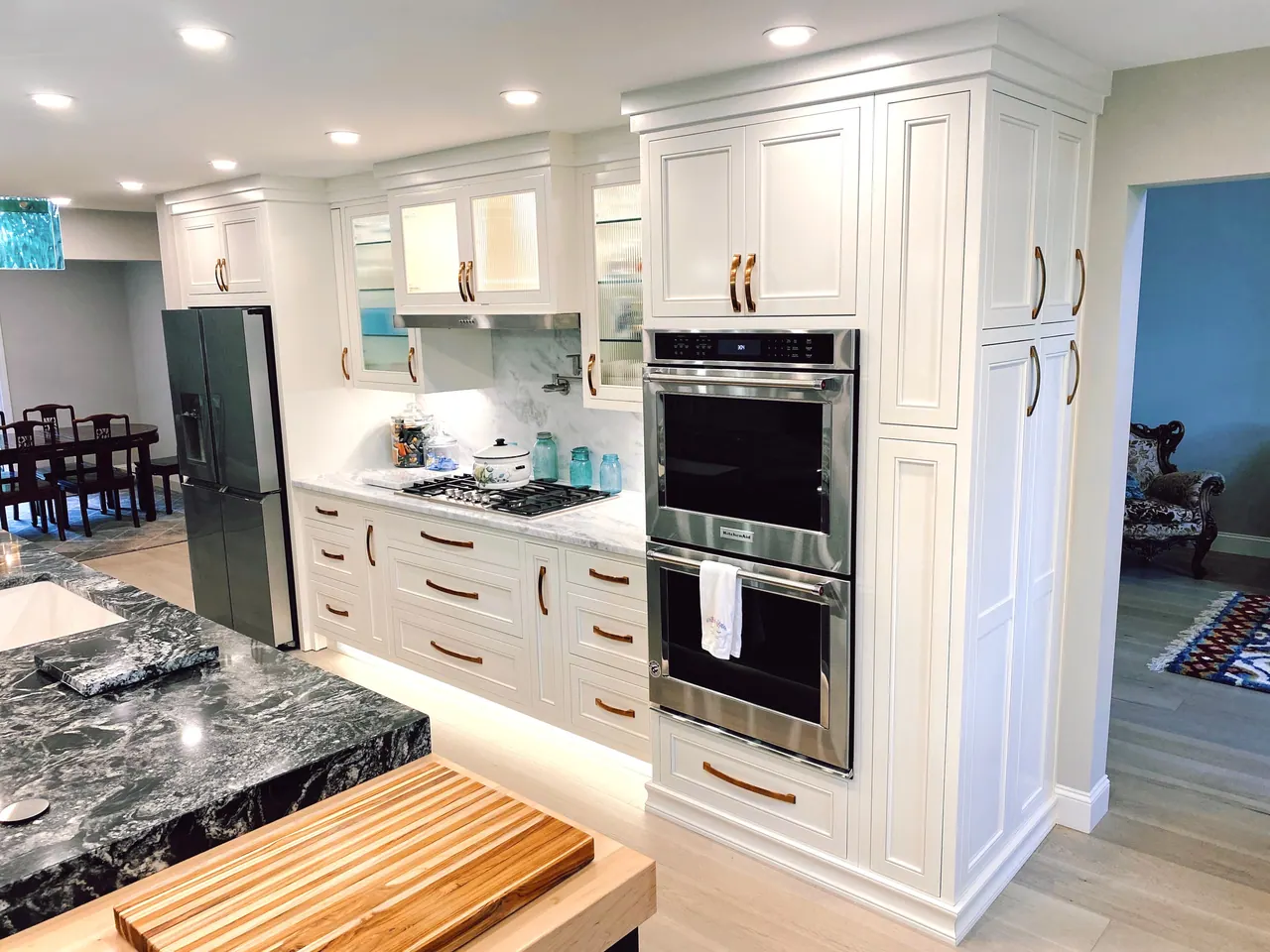 White wall ovens and glass-front upper cabinets