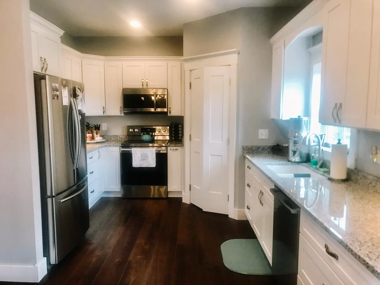 White galley kitchen with dark floors