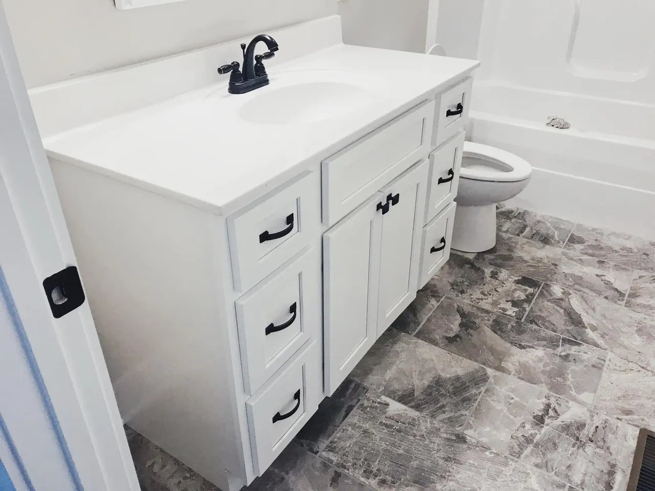 White bathroom vanity with black hardware