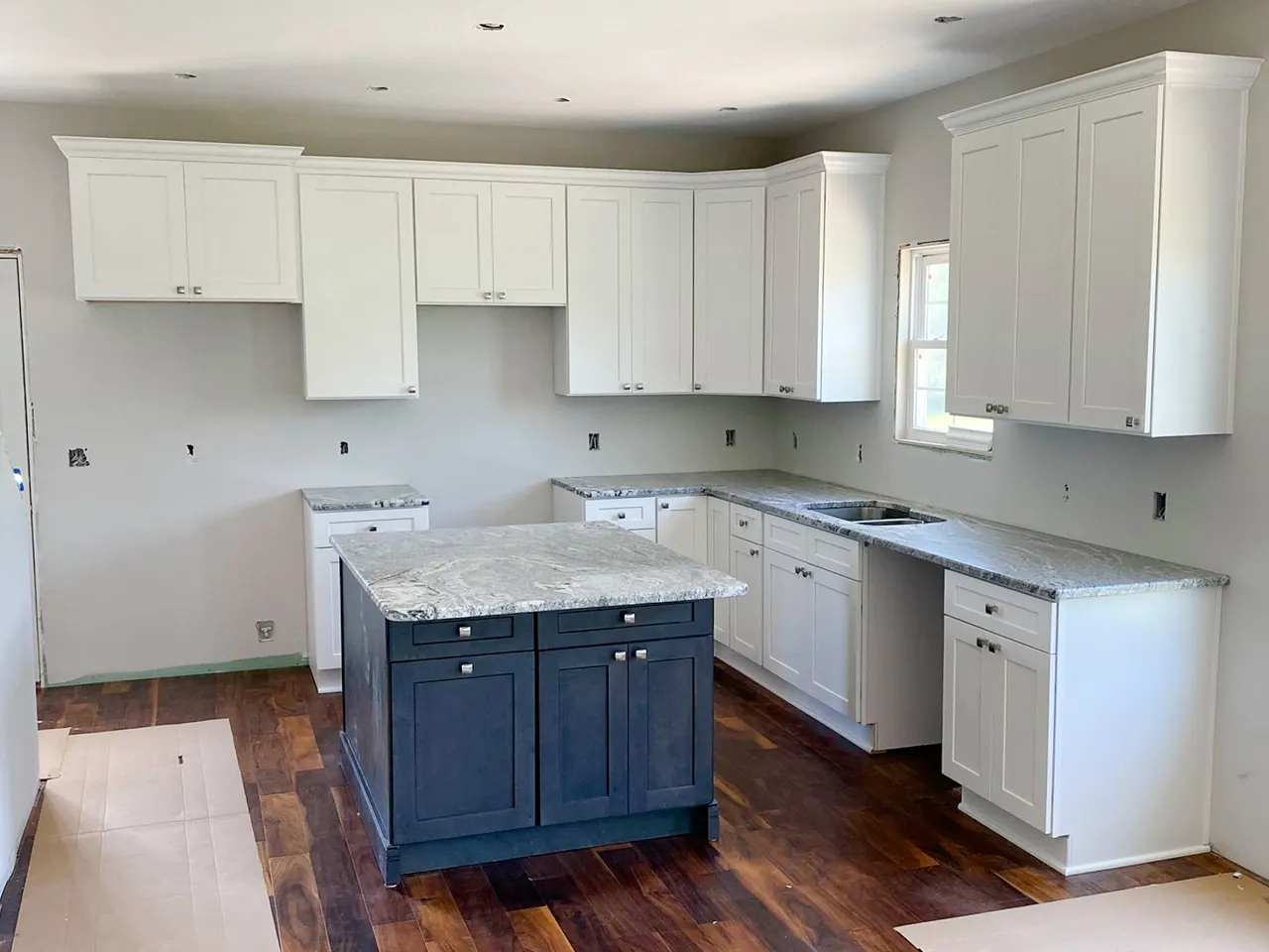 White kitchen with navy island