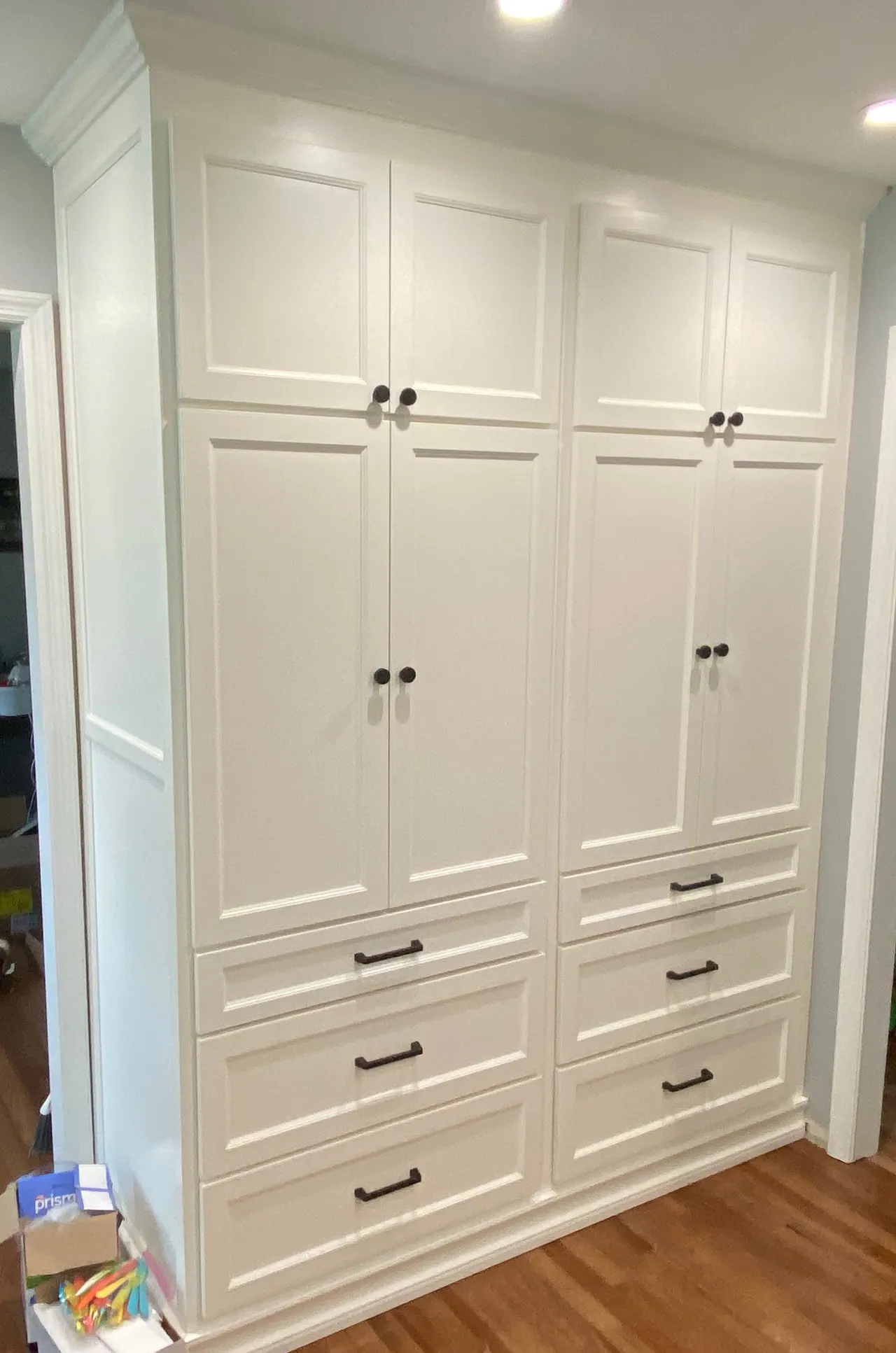Tall white pantry cabinet wall