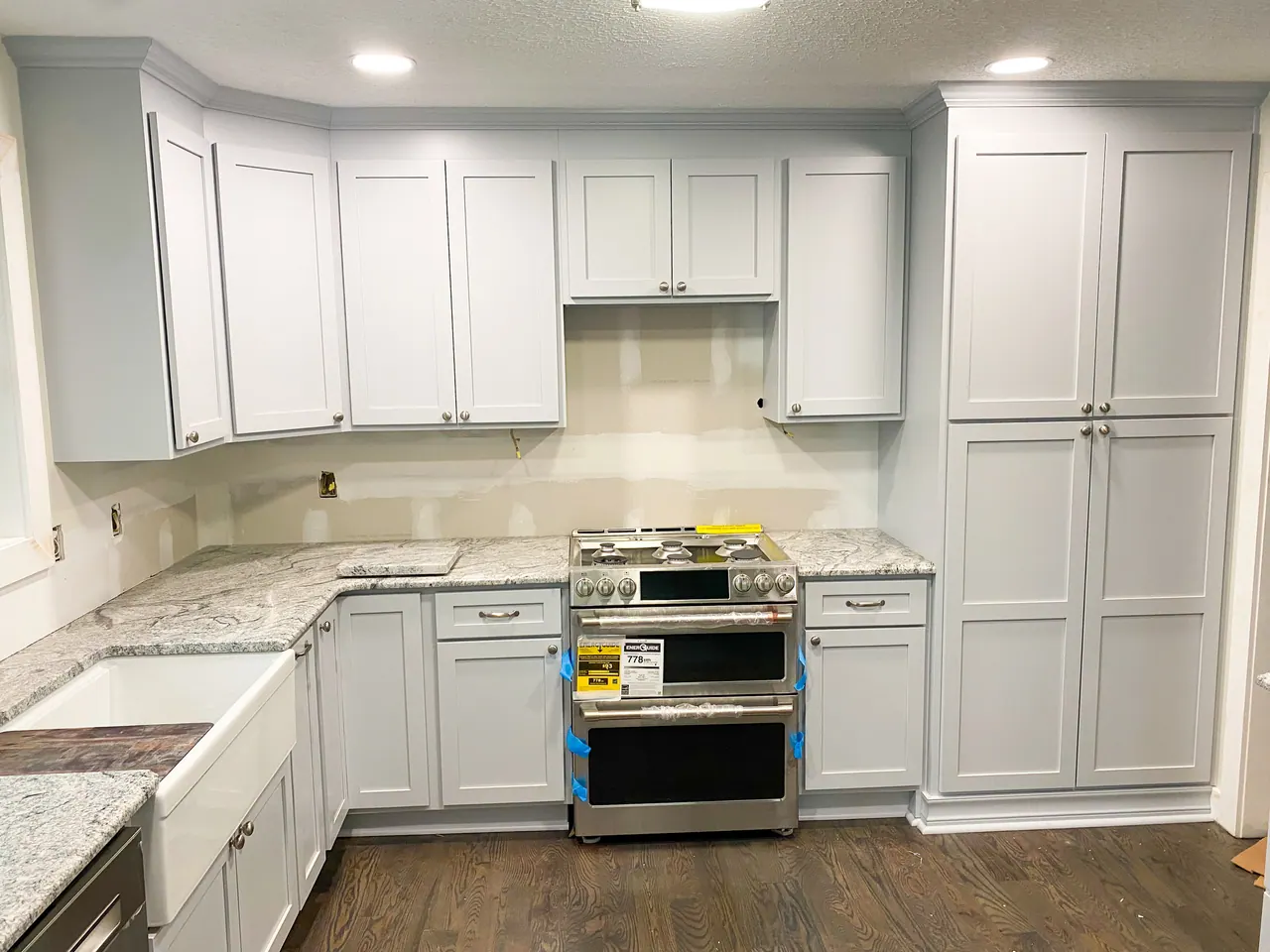 White kitchen with granite counters and stainless range