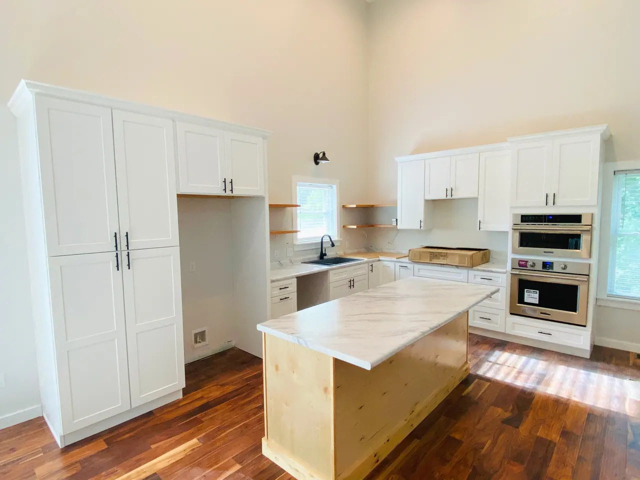 White kitchen with natural wood island