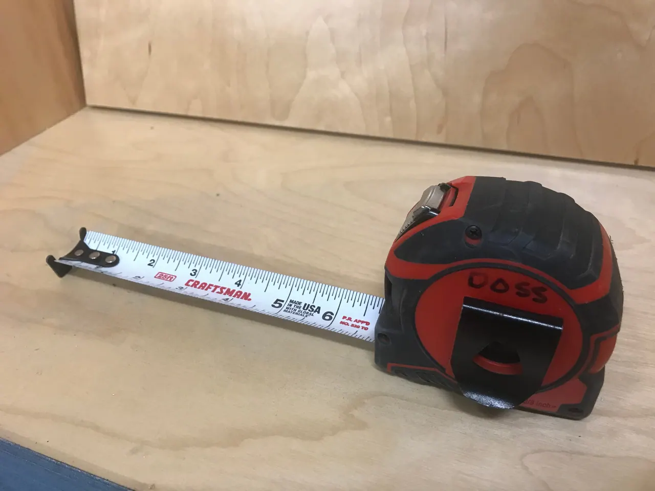 Doss Cabinets tape measure on a sheet of cabinet-grade plywood