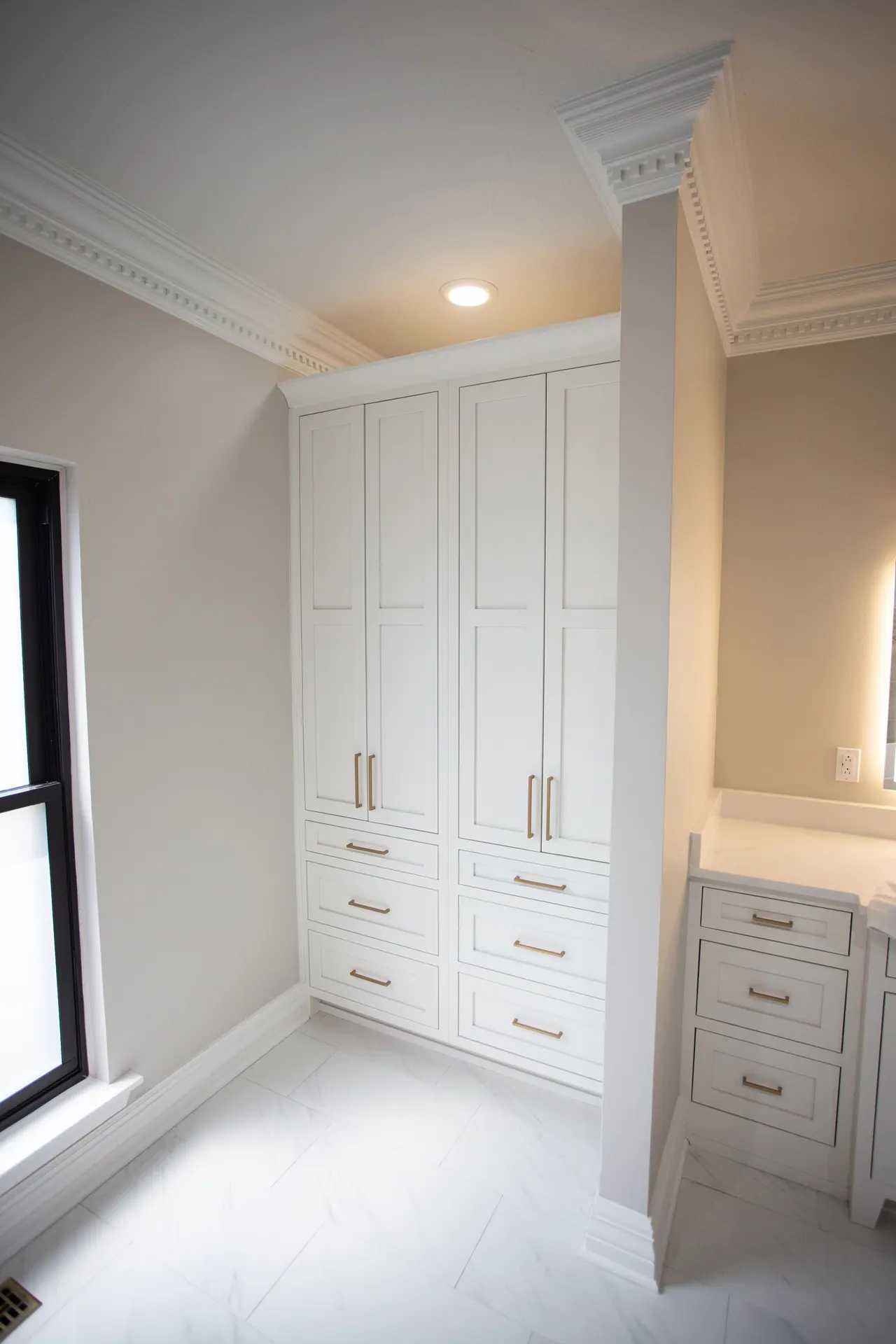 Floor-to-ceiling white storage cabinets