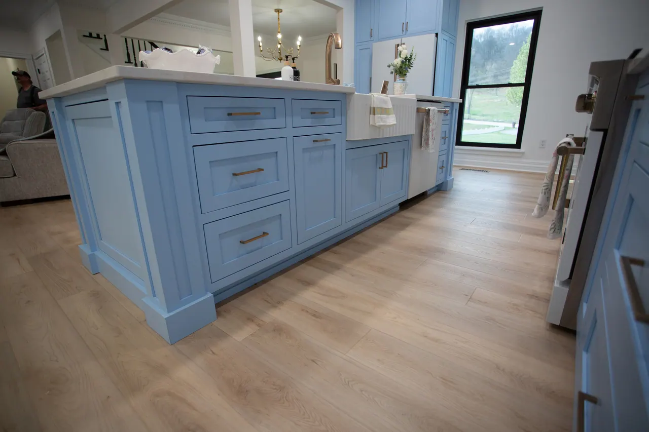 Blue island with deep drawer stacks and wood-look flooring