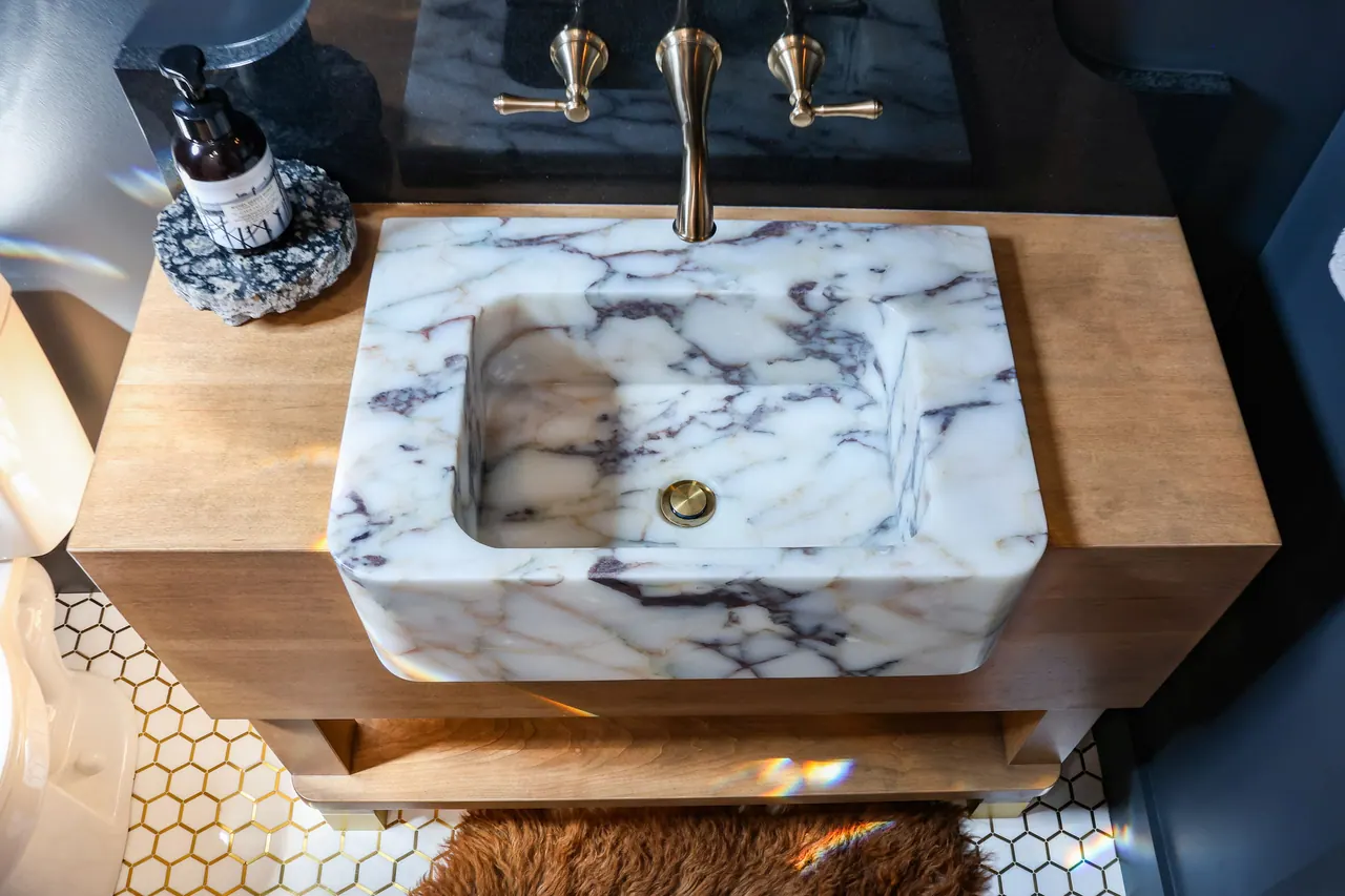 Furniture-style wood vanity with an integrated marble sink